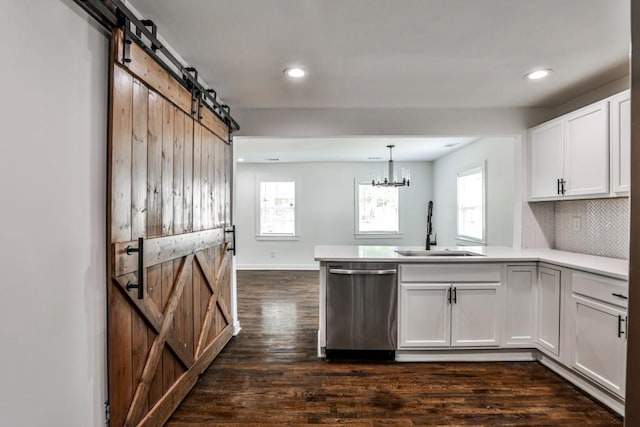 2195 Penelope St NW, Atlanta, GA 30314 - kitchen with a peninsula, a healthy amount of sunlight, a barn door, a sink, and dishwasher