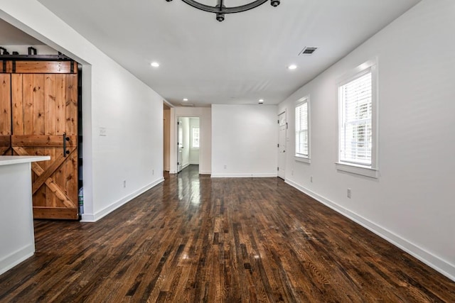 2195 Penelope St NW, Atlanta, GA 30314 - unfurnished living room featuring visible vents, a barn door, wood-type flooring, and recessed lighting