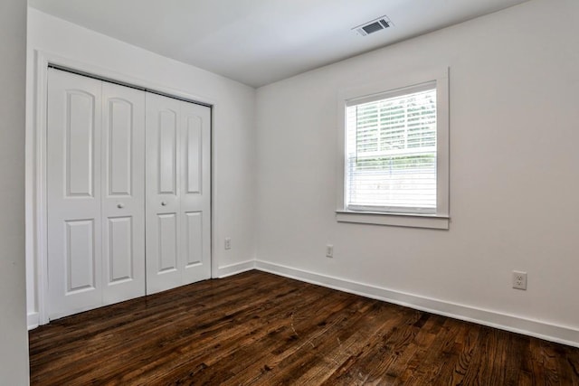 2195 Penelope St NW, Atlanta, GA 30314 - unfurnished bedroom featuring baseboards, a closet, dark wood finished floors, and visible vents