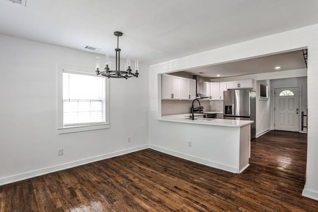 2195 Penelope St NW, Atlanta, GA 30314 - kitchen with dark wood-style flooring, a peninsula, light countertops, a chandelier, and a sink