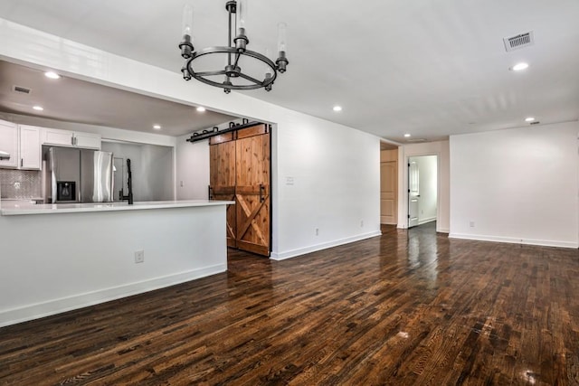 2195 Penelope St NW, Atlanta, GA 30314 - unfurnished living room featuring visible vents, wood finished floors, baseboards, recessed lighting, and a barn door