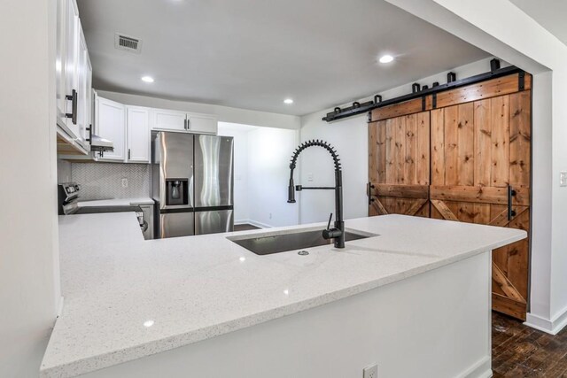 2195 Penelope St NW, Atlanta, GA 30314 - kitchen with white cabinets, light stone countertops, appliances with stainless steel finishes, dark wood finished floors, and visible vents