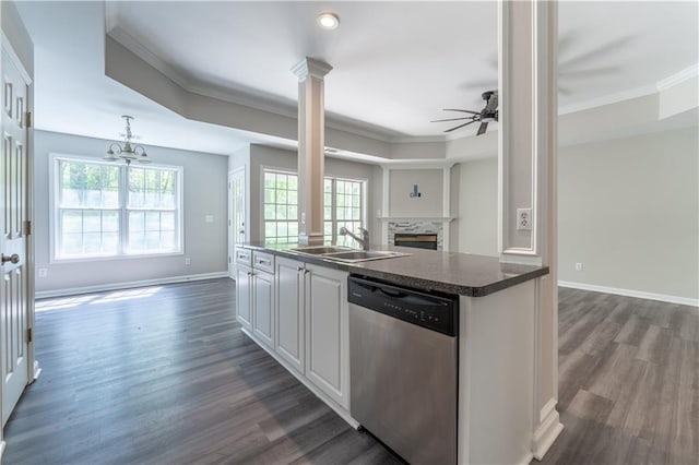 kitchen with dark wood-style floors, a sink, open floor plan, crown molding, and dishwasher