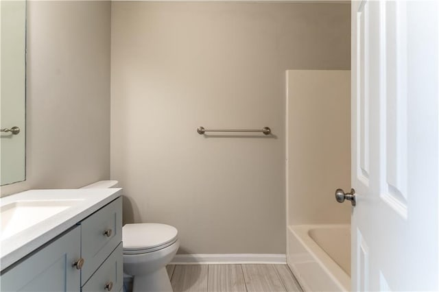 full bath with toilet, baseboards, walk in shower, vanity, and a tub