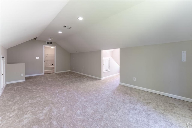 additional living space featuring lofted ceiling, carpet floors, visible vents, and baseboards