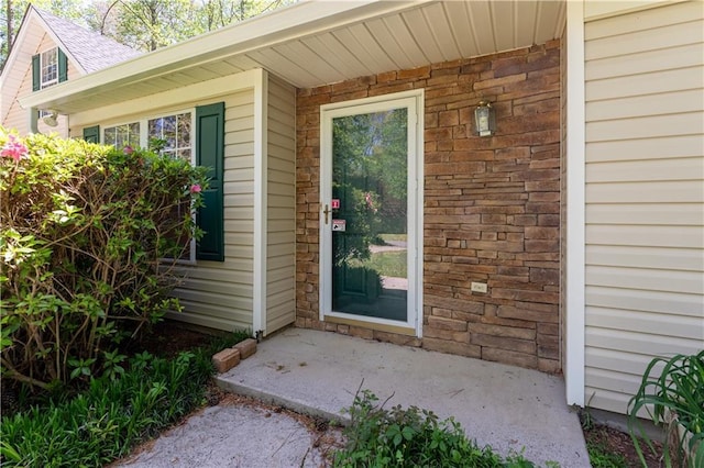 view of exterior entry featuring stone siding