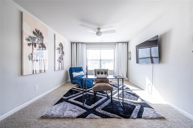 living area featuring carpet floors and ceiling fan