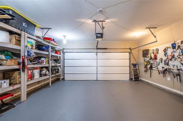 garage with a workshop area and a garage door opener