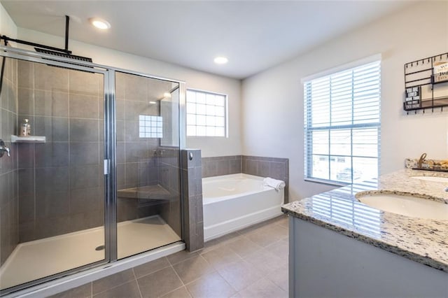 bathroom featuring tile patterned flooring, vanity, and shower with separate bathtub