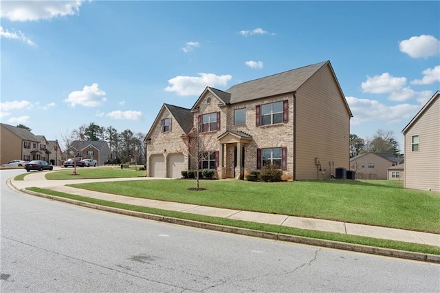 view of front of home featuring stone siding, a garage, driveway, and a front yard