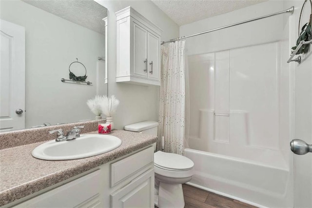 2551 Luther Bailey Rd, Senoia, GA 30276 - bathroom featuring a textured ceiling, vanity, wood finished floors, and shower / bathtub combination with curtain