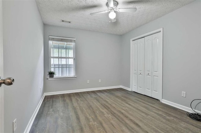 2551 Luther Bailey Rd, Senoia, GA 30276 - unfurnished bedroom with a textured ceiling, wood finished floors, a closet, and ceiling fan