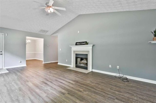 2551 Luther Bailey Rd, Senoia, GA 30276 - unfurnished living room with a textured ceiling, wood finished floors, a ceiling fan, a fireplace with flush hearth, and lofted ceiling