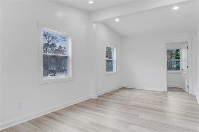 unfurnished room featuring a healthy amount of sunlight, baseboards, and light wood finished floors