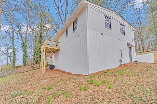 view of side of home featuring central AC unit and a deck