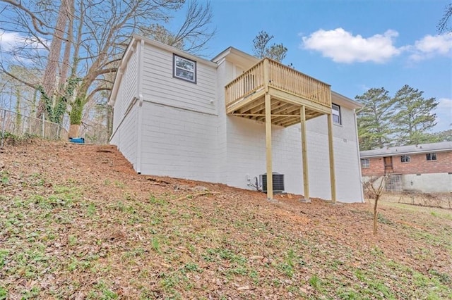 back of house featuring a deck and central AC