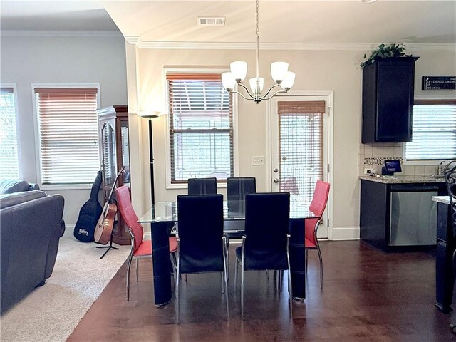 dining area featuring a wealth of natural light, visible vents, ornamental molding, and a chandelier