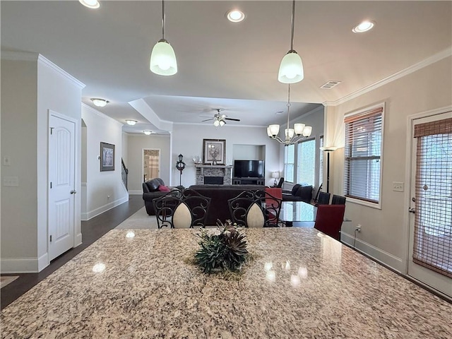 kitchen with crown molding, visible vents, ceiling fan with notable chandelier, and plenty of natural light