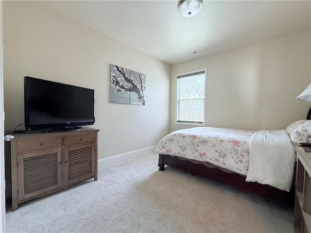 bedroom featuring baseboards, light colored carpet, and visible vents