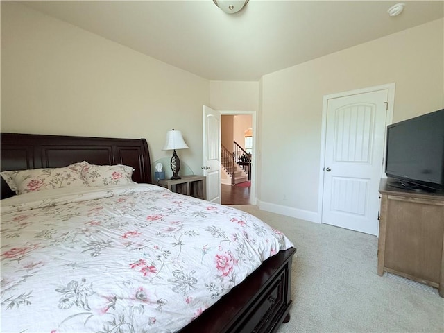 carpeted bedroom featuring baseboards