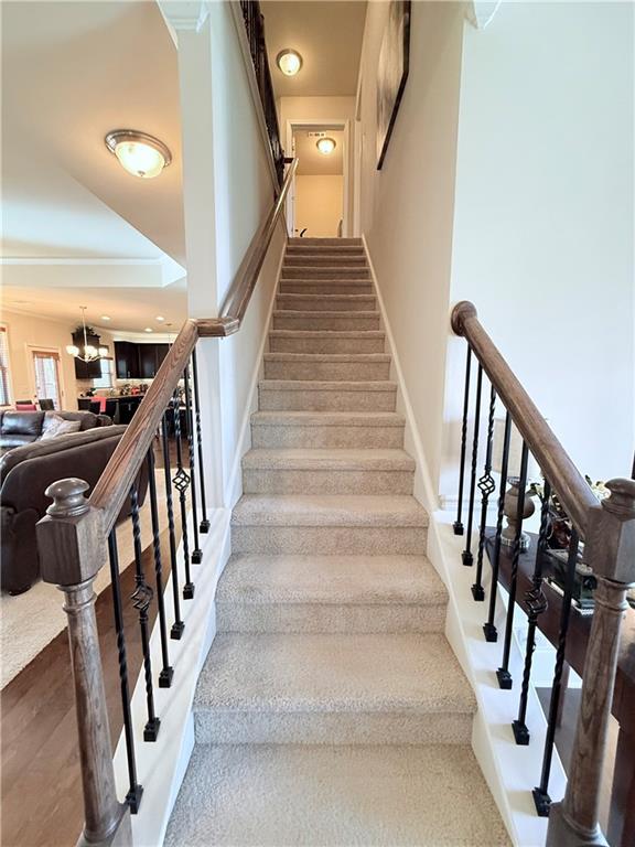 stairway with baseboards and wood finished floors