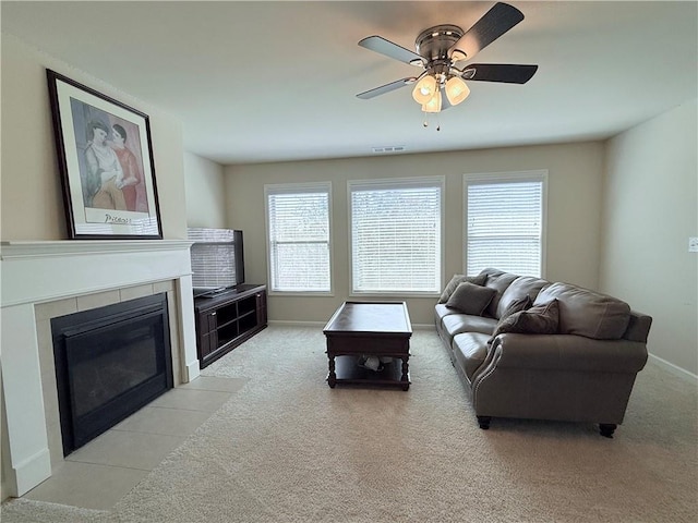 living room with visible vents, a healthy amount of sunlight, and light carpet
