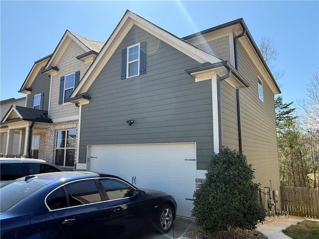 view of property exterior featuring a garage and fence