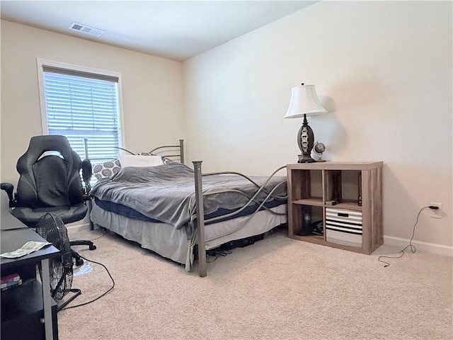 carpeted bedroom featuring baseboards and visible vents