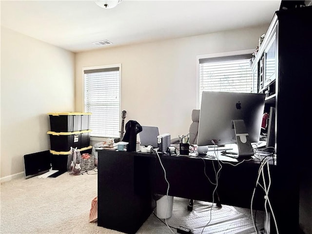 carpeted office featuring baseboards and visible vents