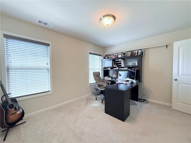 carpeted office featuring baseboards and visible vents