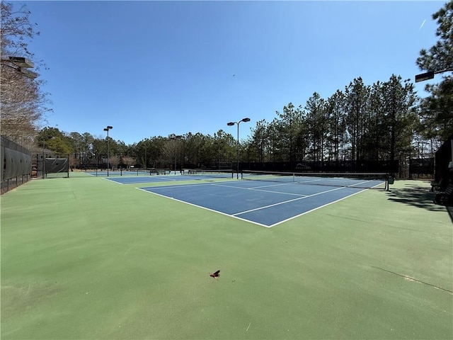 view of tennis court with fence