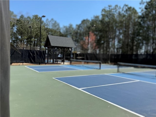 view of sport court featuring community basketball court and fence