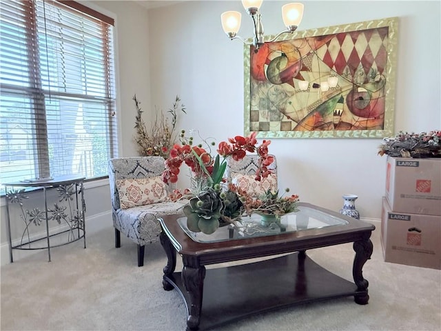 sitting room featuring carpet floors and a chandelier