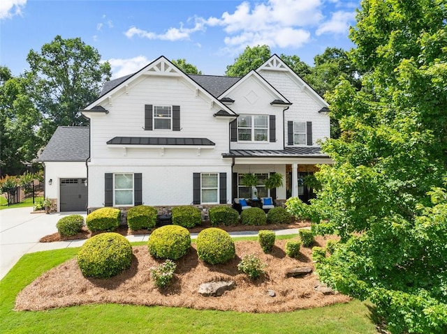 2213 Independence Ln, Buford, GA 30519 - view of front of property featuring a standing seam roof, concrete driveway, an attached garage, roof with shingles, and a metal roof