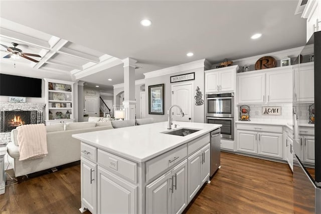 2213 Independence Ln, Buford, GA 30519 - kitchen with decorative columns, crown molding, ceiling fan, stainless steel appliances, and recessed lighting