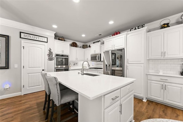 2213 Independence Ln, Buford, GA 30519 - kitchen featuring appliances with stainless steel finishes, decorative backsplash, white cabinets, dark wood-type flooring, and light countertops