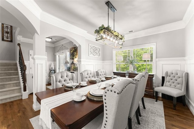 2213 Independence Ln, Buford, GA 30519 - dining area with arched walkways, healthy amount of natural light, a wainscoted wall, ornamental molding, and a decorative wall