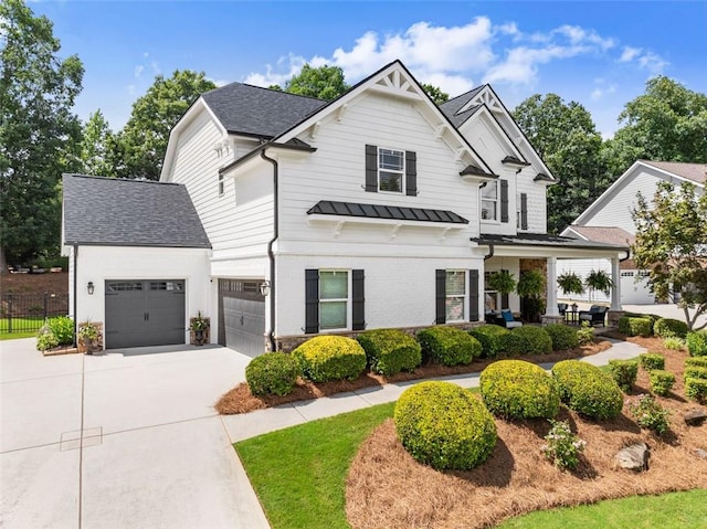 2213 Independence Ln, Buford, GA 30519 - modern inspired farmhouse with concrete driveway, a standing seam roof, a shingled roof, a metal roof, and brick siding