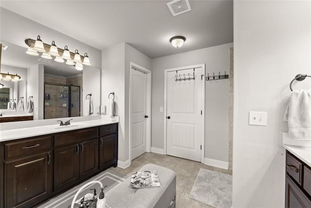2213 Independence Ln, Buford, GA 30519 - full bathroom with a shower stall, two vanities, and tile patterned flooring