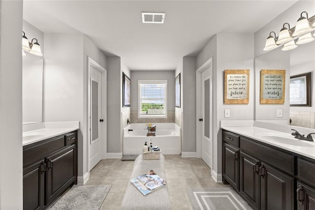 2213 Independence Ln, Buford, GA 30519 - bathroom with a bath, two vanities, and tile patterned flooring