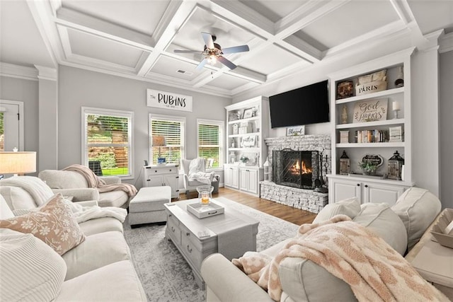 2213 Independence Ln, Buford, GA 30519 - living room featuring wood finished floors, a stone fireplace, ceiling fan, ornamental molding, and beamed ceiling