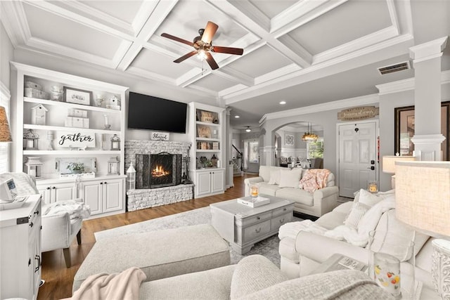 2213 Independence Ln, Buford, GA 30519 - living area with ornate columns, wood finished floors, a ceiling fan, arched walkways, and beamed ceiling