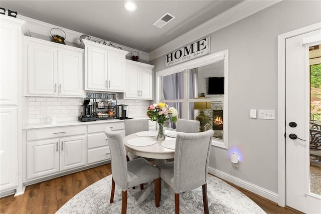 2213 Independence Ln, Buford, GA 30519 - dining space with crown molding, dark wood-style floors, and recessed lighting