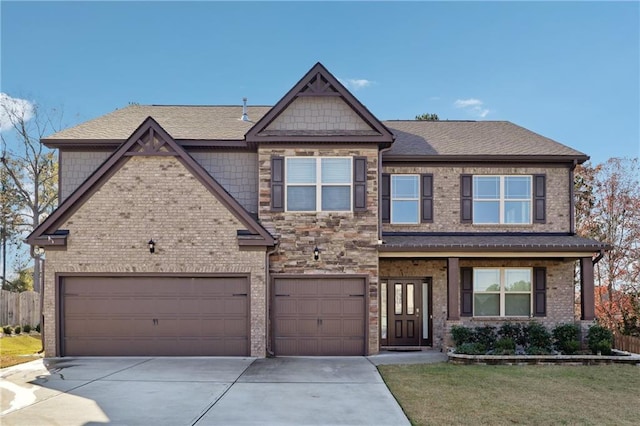 craftsman inspired home with a front yard and a garage