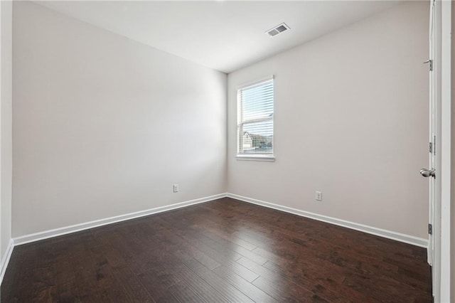 empty room featuring dark hardwood / wood-style flooring