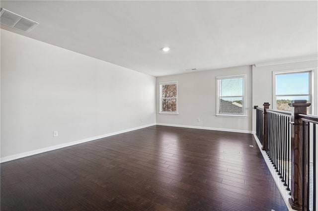 spare room featuring dark hardwood / wood-style flooring