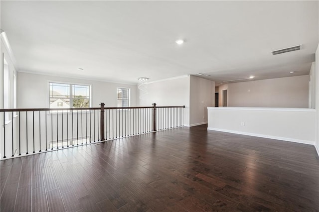 empty room featuring a chandelier and dark hardwood / wood-style floors