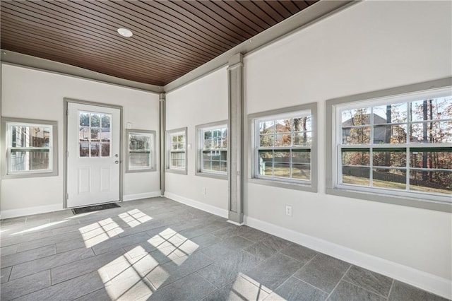 unfurnished sunroom featuring wood ceiling