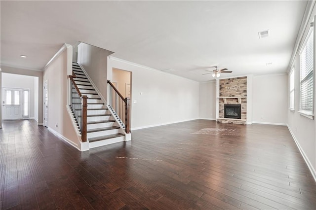 unfurnished living room featuring ceiling fan, a stone fireplace, dark hardwood / wood-style flooring, and crown molding