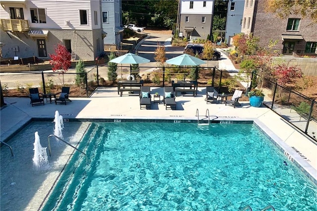 pool featuring a patio and fence